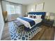 Nicely decorated bedroom features a large bed, bench, and patterned rug at 405 Fairburn Sw Rd # 231, Atlanta, GA 30331