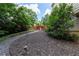 View of backyard landscaping, mulch ground cover, and a wooden fence and gate at 5287 Wild Indigo Way, Acworth, GA 30102