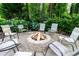 Backyard firepit area with chairs surrounded by lush landscaping and trees at 5287 Wild Indigo Way, Acworth, GA 30102