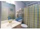 Charming bathroom with blue and yellow accents, including a vanity mirror, and a shower curtain with matching floral details at 5287 Wild Indigo Way, Acworth, GA 30102