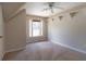 Bright bedroom featuring a ceiling fan, neutral paint, carpeted floor, and built-in shelving for ample storage at 5287 Wild Indigo Way, Acworth, GA 30102