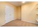 An empty carpeted bedroom with cream colored walls and a double door closet at 5287 Wild Indigo Way, Acworth, GA 30102