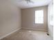 Cozy bedroom with neutral carpet and window offering natural light, creating a simple and comfortable space for relaxation at 5287 Wild Indigo Way, Acworth, GA 30102