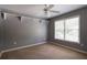 Neutral toned bedroom featuring a ceiling fan, carpeted floor, a window, and decorative shelving at 5287 Wild Indigo Way, Acworth, GA 30102