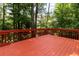 Exterior shot of a spacious deck with a wooden railing, providing views of the wooded backyard at 5287 Wild Indigo Way, Acworth, GA 30102