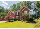 Beautiful two-story brick home with well-manicured lawn, mature trees, and symmetrical design, exuding classic elegance and curb appeal at 5287 Wild Indigo Way, Acworth, GA 30102