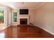 Bright and airy living room with hardwood floors, a fireplace, and large windows for natural light at 5287 Wild Indigo Way, Acworth, GA 30102