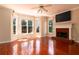 Inviting living room with hardwood floors, a fireplace, and large windows for natural light at 5287 Wild Indigo Way, Acworth, GA 30102