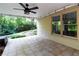 Covered outdoor patio with ceiling fan, tiled floor, and views of backyard at 5287 Wild Indigo Way, Acworth, GA 30102