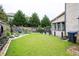 Spacious backyard featuring a lush lawn, rock garden and tall trees at 552 Warrenton Run Dr, Sugar Hill, GA 30518