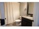 Clean bathroom featuring a shower with a decorative curtain, a toilet, and a vanity at 552 Warrenton Run Dr, Sugar Hill, GA 30518