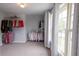 Spacious walk-in closet with ample shelving and storage for clothes and accessories at 552 Warrenton Run Dr, Sugar Hill, GA 30518