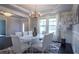 Elegant dining room featuring a stunning chandelier, hardwood floors, and windows at 552 Warrenton Run Dr, Sugar Hill, GA 30518