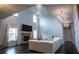 Spacious living room with a stone fireplace, high ceilings, and ample natural light at 552 Warrenton Run Dr, Sugar Hill, GA 30518