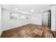Bedroom featuring white walls, trim, windows, hardwood floors, and a black door at 1092 Donnelly Sw Ave, Atlanta, GA 30310