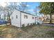 View of a home with recently updated white siding and a lawn in need of care at 1092 Donnelly Sw Ave, Atlanta, GA 30310