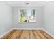 Light-filled bedroom showcasing luxury vinyl plank flooring and large bright window at 1283 Mercer, East Point, GA 30344