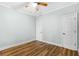 Bedroom features modern wood-look floors, white trim, ceiling fan, and closet at 1283 Mercer, East Point, GA 30344