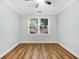 Bright bedroom features wood-look floors, a ceiling fan, and a sunlit window at 1283 Mercer, East Point, GA 30344
