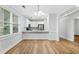 Open dining room with modern lighting, hardwood floors, and abundant natural light at 1283 Mercer, East Point, GA 30344