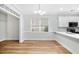 Bright dining area featuring a modern chandelier, large windows, and an open kitchen view at 1283 Mercer, East Point, GA 30344