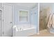 Bathroom featuring a separate tub and glass-enclosed shower at 1609 Vinery Se Ln, Mableton, GA 30126