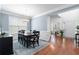 Elegant dining room with hardwood floors, wainscoting, and a modern chandelier at 1609 Vinery Se Ln, Mableton, GA 30126