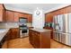 Updated kitchen with stainless steel appliances, dark wood cabinets, and a center island at 1609 Vinery Se Ln, Mableton, GA 30126