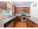 Functional kitchen with stainless appliances, granite counters, and hardwood floors at 1609 Vinery Se Ln, Mableton, GA 30126