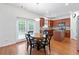 Kitchen and dining area features wood cabinets and stainless appliances plus a wood table at 1609 Vinery Se Ln, Mableton, GA 30126