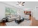 Sunlit living room with modern sofas and wooden floor with neutral rug at 1609 Vinery Se Ln, Mableton, GA 30126