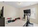 A workout area with exercise bike, weights, television and mirror at 1609 Vinery Se Ln, Mableton, GA 30126
