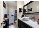 Well-lit bathroom featuring a modern vanity, vessel sink, sleek fixtures, and a shower with modern tile at 325 Harris Loop, Dallas, GA 30157
