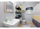 Bright bathroom features a clean sink, floating shelving, and coordinated décor elements at 325 Harris Loop, Dallas, GA 30157