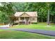 Charming single Gathering home featuring a quaint front porch with beautiful lawn and mature trees at 325 Harris Loop, Dallas, GA 30157