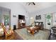 Bright living room featuring a rocking chair, television, and access to other rooms at 325 Harris Loop, Dallas, GA 30157