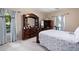 Spacious main bedroom with a decorative bed frame, dresser with a large mirror, and bright natural light at 325 Harris Loop, Dallas, GA 30157