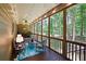 Relaxing screened porch with outdoor seating and wooded views, perfect for enjoying nature at 325 Harris Loop, Dallas, GA 30157