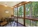 Relaxing screened porch with seating area, offering a peaceful view of the backyard and natural surroundings at 325 Harris Loop, Dallas, GA 30157
