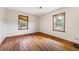 A clean, bright bedroom with hardwood floors and natural light shining through the windows at 1191 S Burnt Hickory Rd, Douglasville, GA 30134