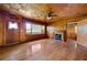 Cozy living room with a decorative fireplace, hardwood floors, and wood paneling at 1191 S Burnt Hickory Rd, Douglasville, GA 30134