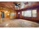 Spacious living room featuring hardwood floors, wood paneled walls, a decorative ceiling, and natural light at 1191 S Burnt Hickory Rd, Douglasville, GA 30134