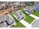 Overhead shot of a home boasting a manicured lawn, long driveway, and a charming, covered front porch at 1784 Treymire Ct, Stone Mountain, GA 30088