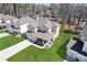 Aerial view of a gray two-story home with a well-maintained lawn, a covered front porch, and a two-car garage at 1784 Treymire Ct, Stone Mountain, GA 30088