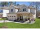Charming two-story home with a covered front porch, stone accents, and a well-manicured lawn at 1784 Treymire Ct, Stone Mountain, GA 30088