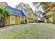 Large backyard with a well-maintained lawn, mature trees, a patio, and lush landscaping at 3034 Brookgreen Trl, Lawrenceville, GA 30043