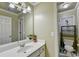 Clean bathroom featuring a white vanity, sink, and a separate toilet and shower area at 3034 Brookgreen Trl, Lawrenceville, GA 30043
