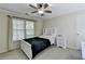 Comfortable bedroom with a ceiling fan, natural light, and a bed with built-in shelving at 3034 Brookgreen Trl, Lawrenceville, GA 30043