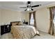 Cozy bedroom with an elegant bed frame, matching end tables, and decorative curtains at 3034 Brookgreen Trl, Lawrenceville, GA 30043