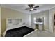 Bedroom with ceiling fan, a vanity with lighted mirror, and a bed with built-in shelving at 3034 Brookgreen Trl, Lawrenceville, GA 30043